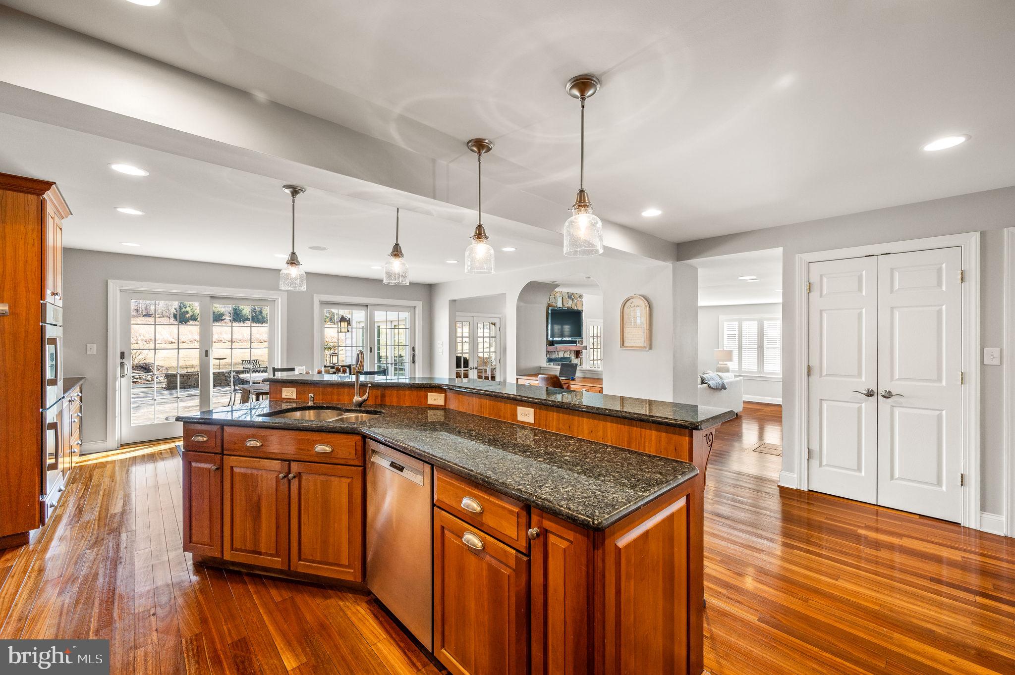 342 Old State Road Berwyn, PA 19312 - Photo 15 of 58 a kitchen with stainless steel appliances granite countertop a sink and wooden floor