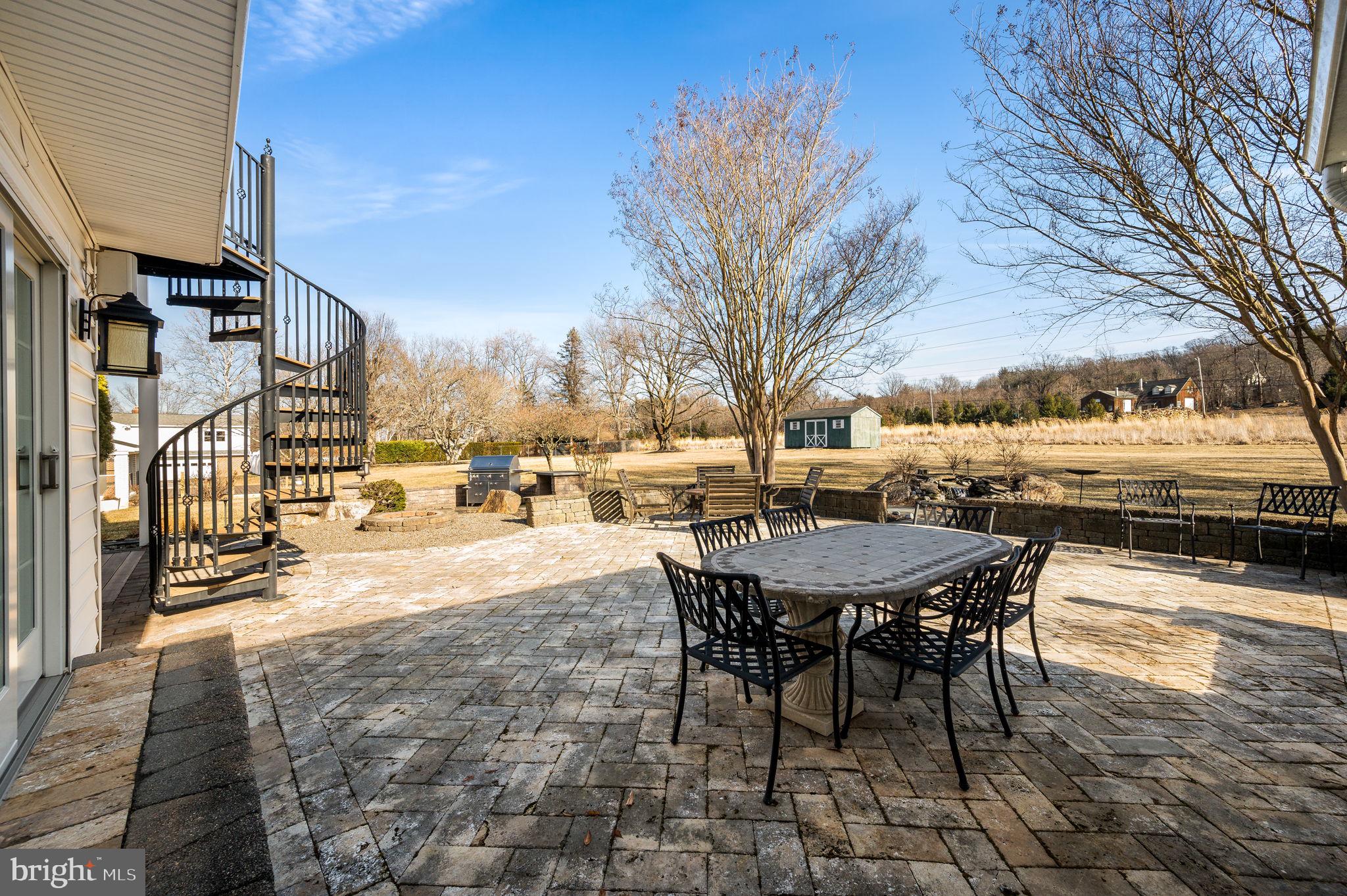 342 Old State Road Berwyn, PA 19312 - Photo 49 of 58 a view of a patio with a table and chairs and couches with wooden fence