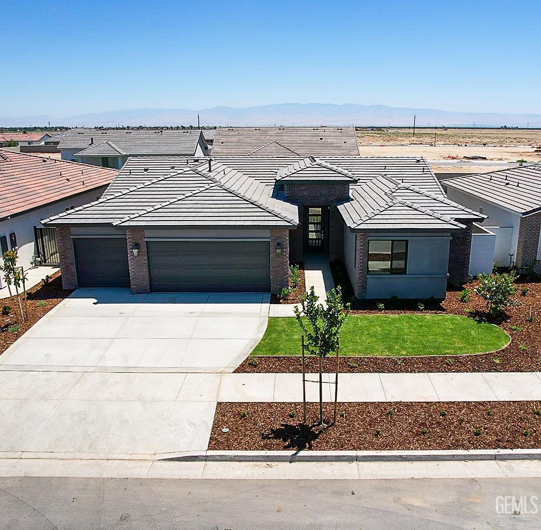 Undisclosed Address Bakersfield, CA 93311 - Photo 1 of 29 a front view of a house with a yard and garage