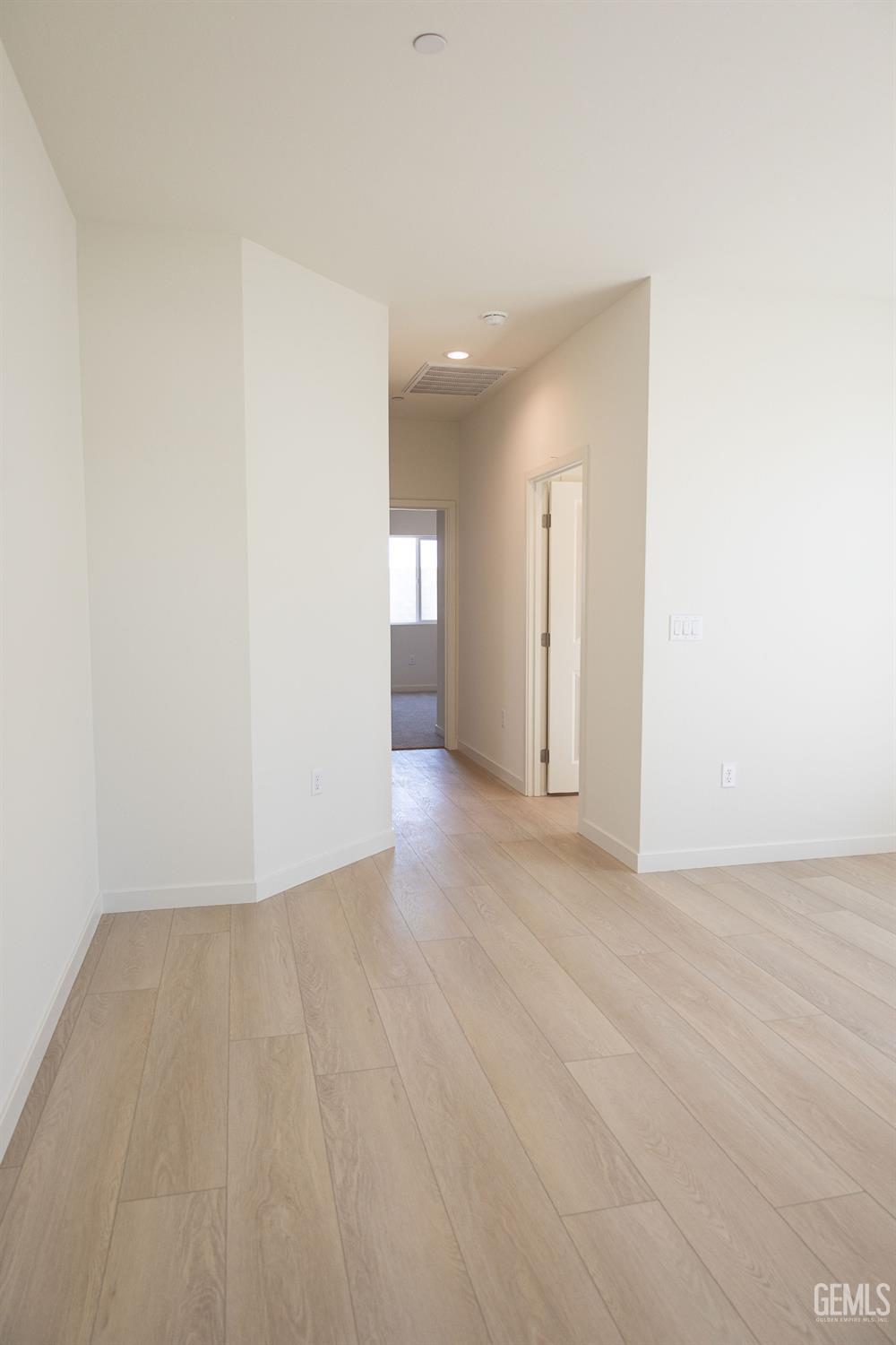 Undisclosed Address Bakersfield, CA 93311 - Photo 13 of 29 a view of an empty room with wooden floor