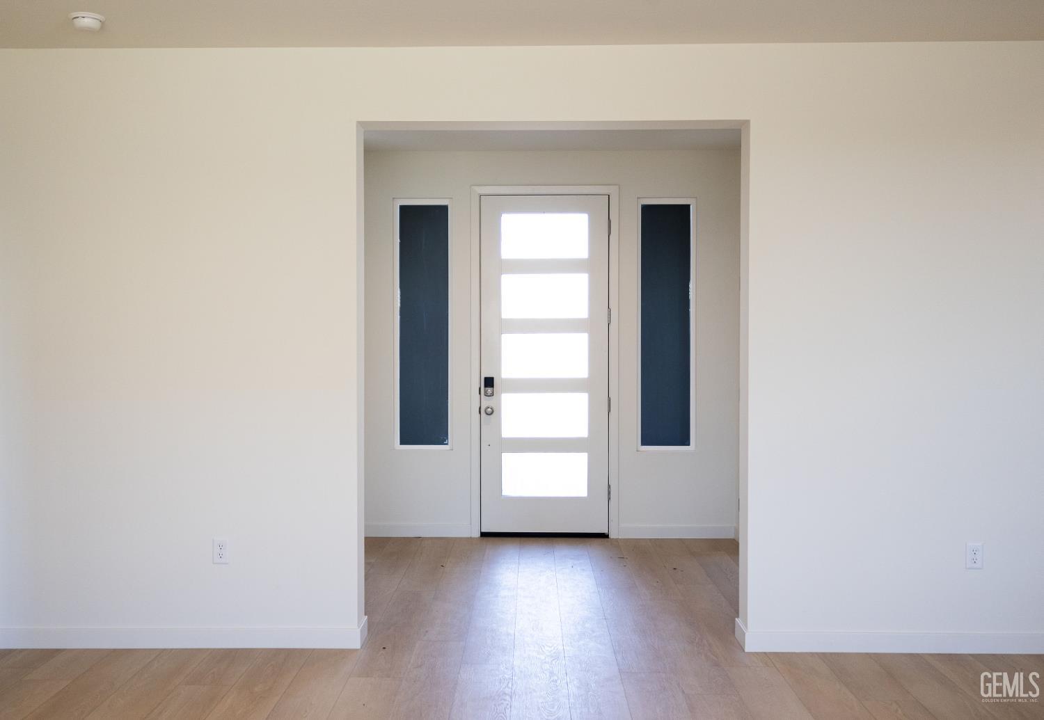 Undisclosed Address Bakersfield, CA 93311 - Photo 4 of 29 an empty room with wooden floor closet and windows