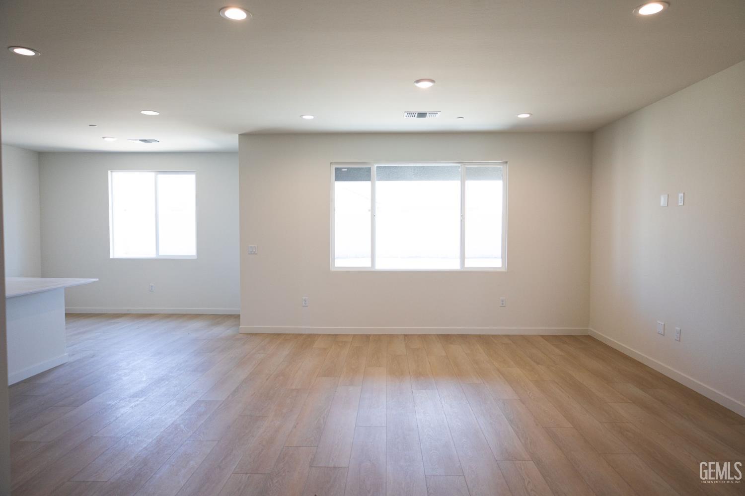 Undisclosed Address Bakersfield, CA 93311 - Photo 5 of 29 a view of an empty room with wooden floor and a window