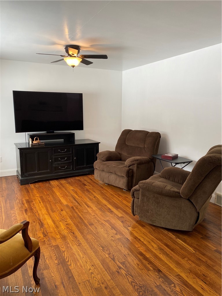 4115 South Ridge Road East Ashtabula, OH 44004 - Photo 7 of 35 Living room 21 x 12 with hardwood flooring and ceiling fan.