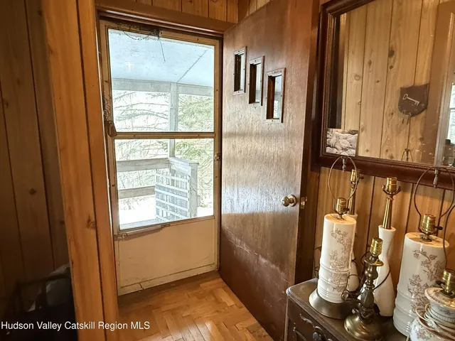 a view of a balcony with furniture and front door