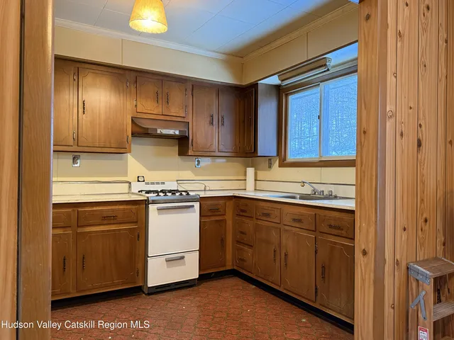 a living room with a fireplace furniture and a floor to ceiling window
