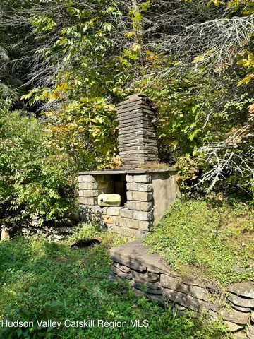 a view of a wooden house with a tree