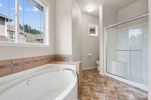 a spacious bedroom with a bed and a couch