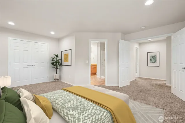 a bedroom with a bed and flat screen tv