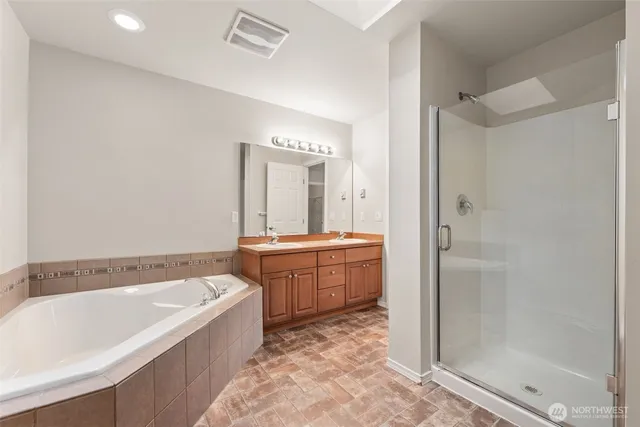 a bedroom with a large bed and wooden floor