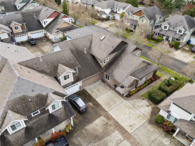 an aerial view of residential houses with yard