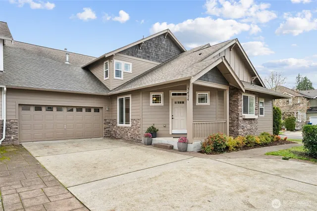 a view of a dining room with furniture a chandelier and wooden floor