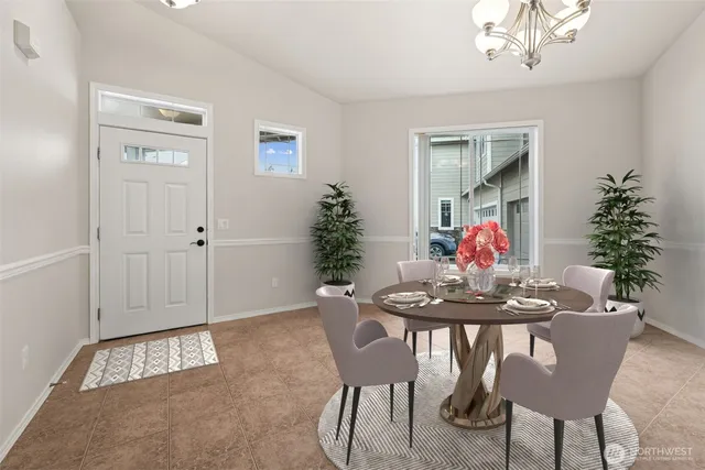 a view of a dining room with furniture and chandelier