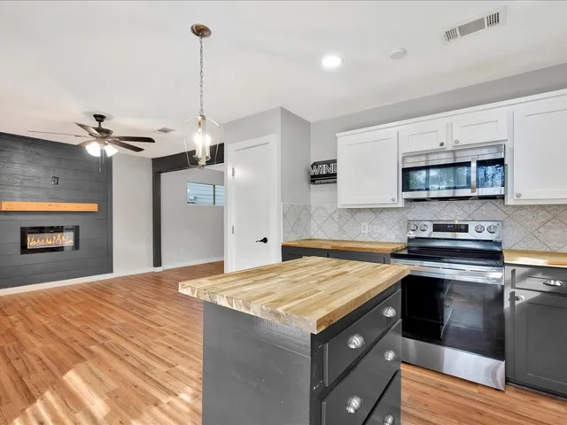 a kitchen with a sink and a stove top oven