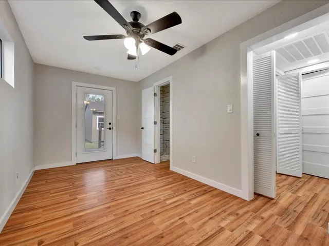 a view of an empty room with wooden floor