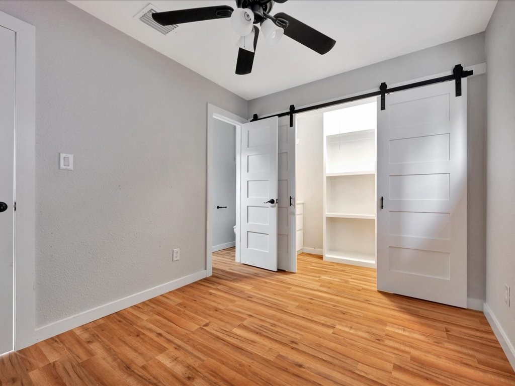 41 Harbour Row Drive Coldspring, TX 77331 - Photo 19 of 36 a view of empty room with wooden floor and ceiling fan