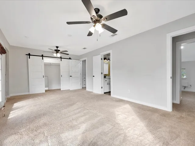 an empty room with fan and a ceiling fan