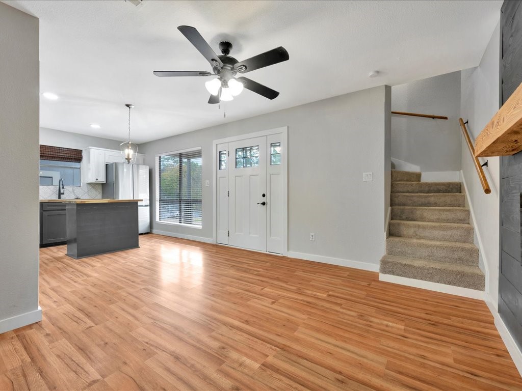 41 Harbour Row Drive Coldspring, TX 77331 - Photo 6 of 36 a view of an empty room with wooden floor and a kitchen
