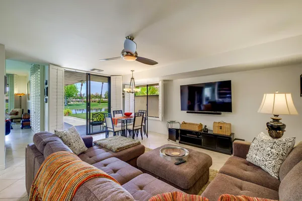 a bedroom with a bed flat screen tv and a large window