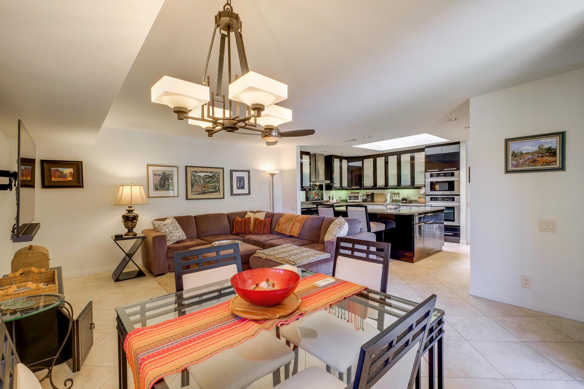 30 Columbia Drive Rancho Mirage, CA 92270 - Photo 26 of 49 a living room with furniture a chandelier and kitchen view