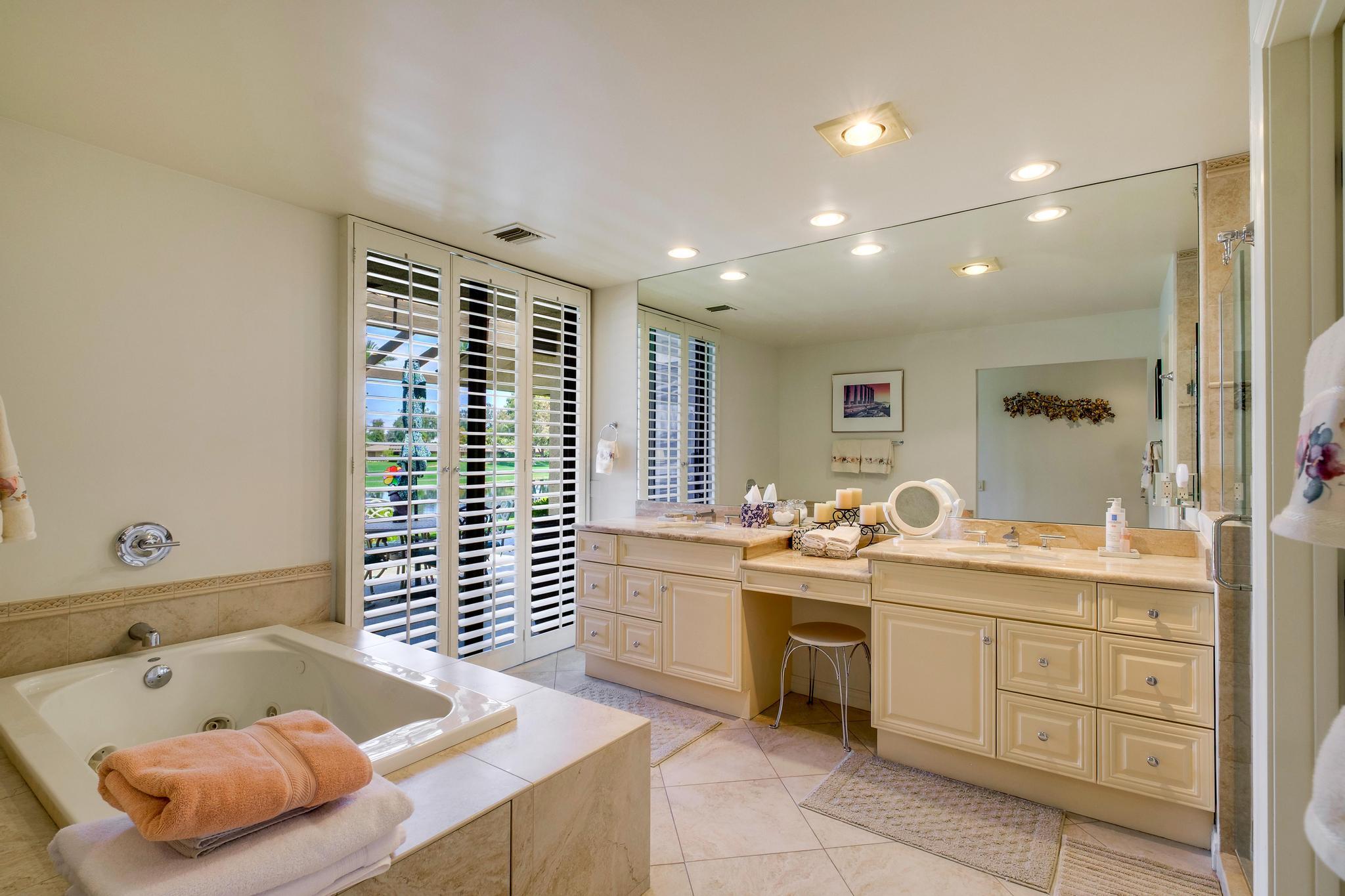 30 Columbia Drive Rancho Mirage, CA 92270 - Photo 28 of 49 a bathroom with a tub sink and mirror