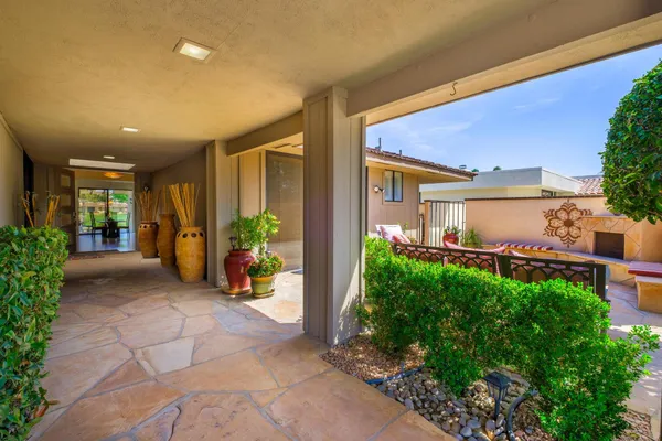 a building outdoor space with patio furniture and potted plants