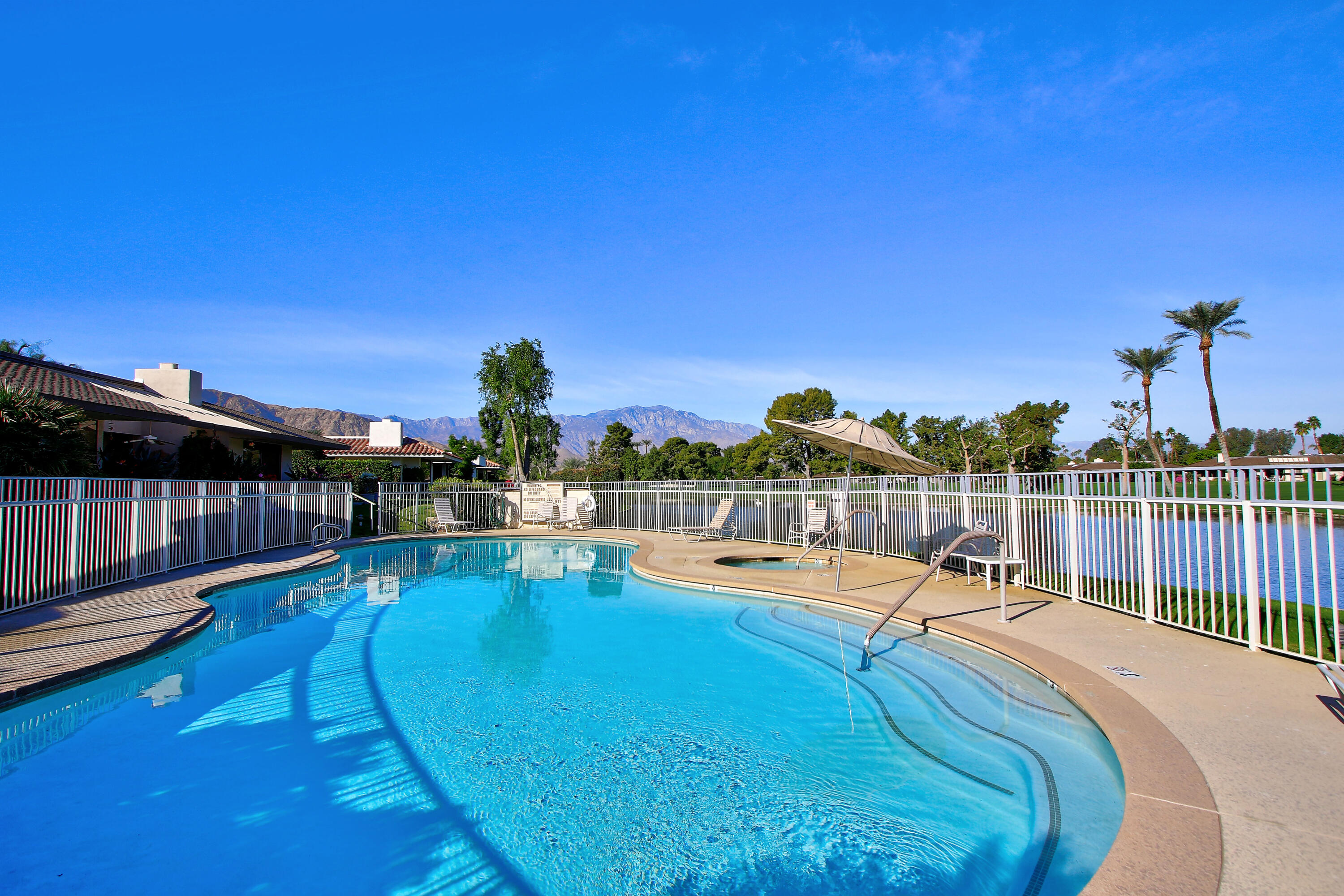 30 Columbia Drive Rancho Mirage, CA 92270 - Photo 45 of 49 a view of a swimming pool with a lounge chairs