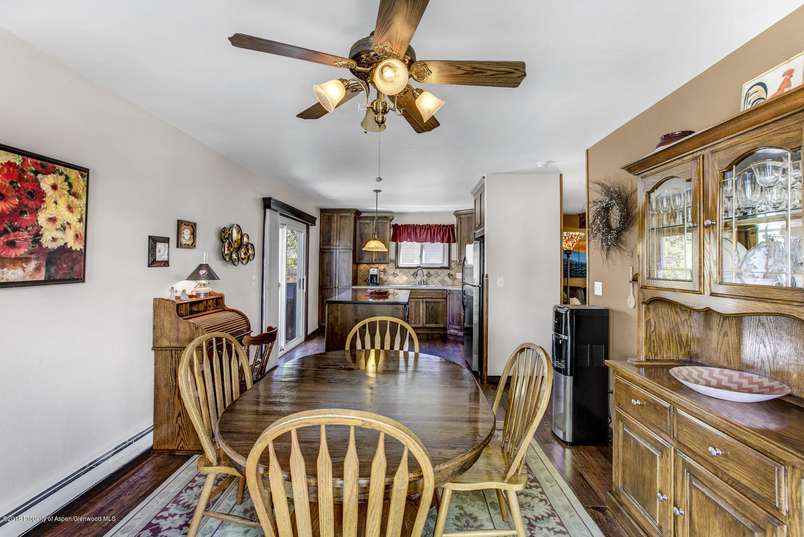 654 Mesa Avenue Rifle, CO 81650 - Photo 9 of 20 a dining room with furniture a chandelier and wooden floor