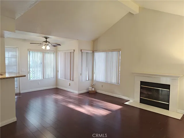 a kitchen with stainless steel appliances granite countertop a refrigerator a sink and wooden cabinets