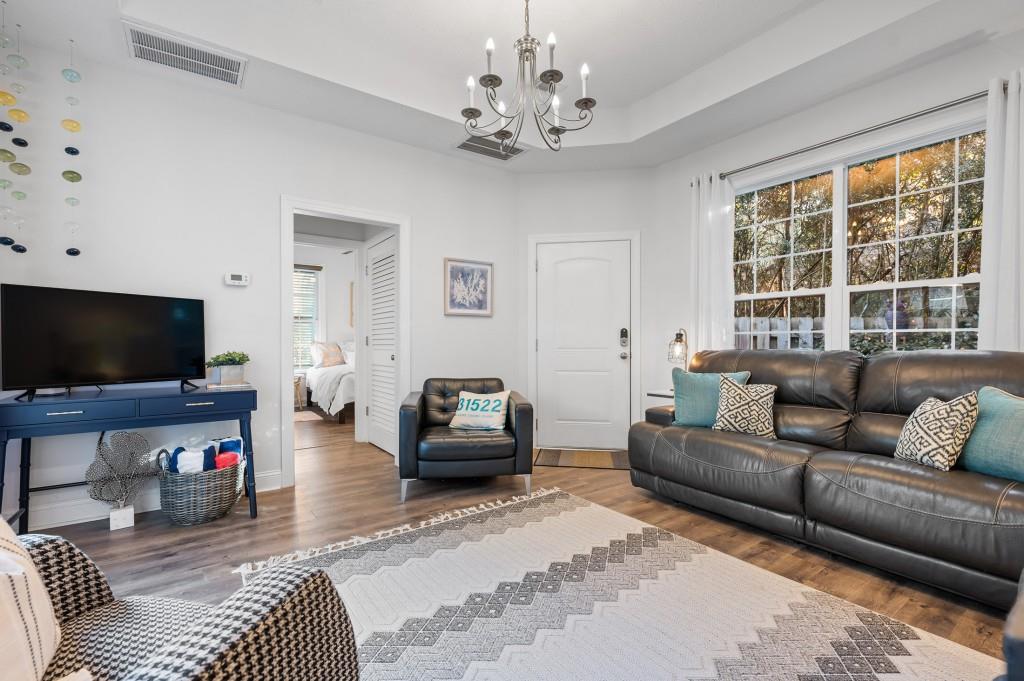 423 Palmetto Street St. Simons, GA 31522 - Photo 12 of 38 a living room with furniture and a flat screen tv