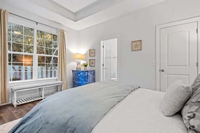 a bedroom with a bed and a large window