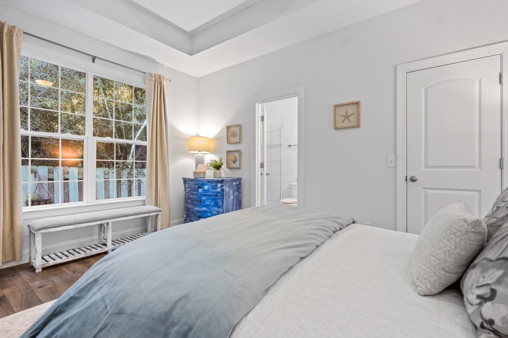 423 Palmetto Street St. Simons, GA 31522 - Photo 15 of 38 a bedroom with a bed and a large window