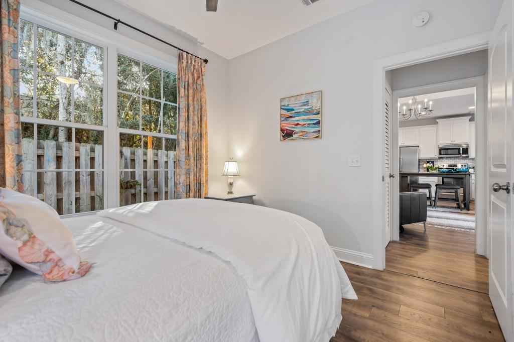 423 Palmetto Street St. Simons, GA 31522 - Photo 20 of 38 a bedroom with a bed and a large window