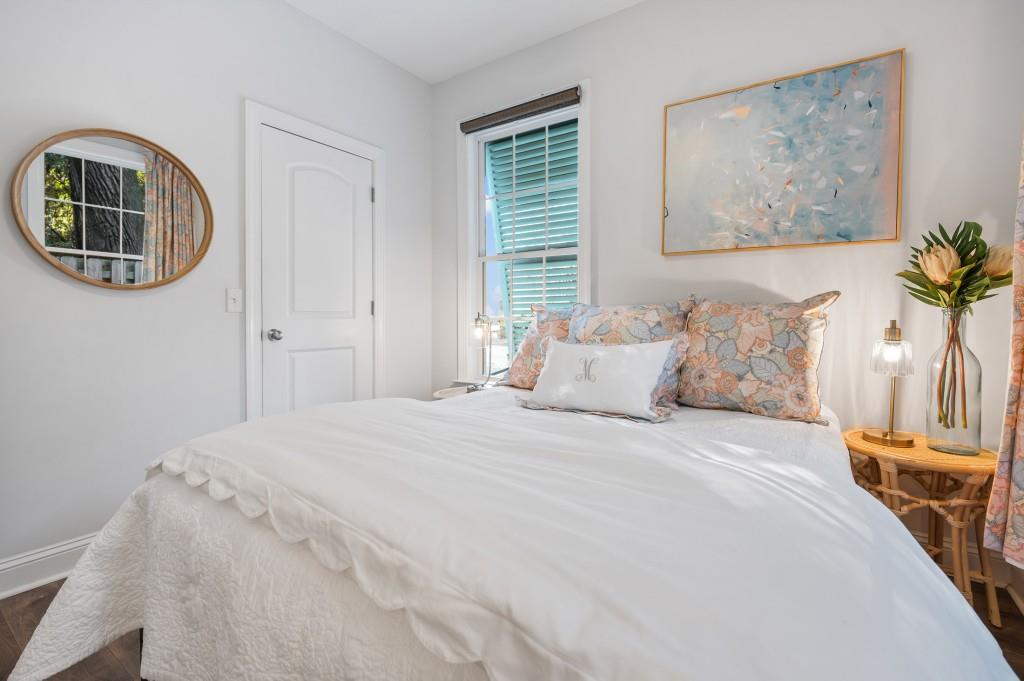 423 Palmetto Street St. Simons, GA 31522 - Photo 21 of 38 a bedroom with a bed and a painting on the wall