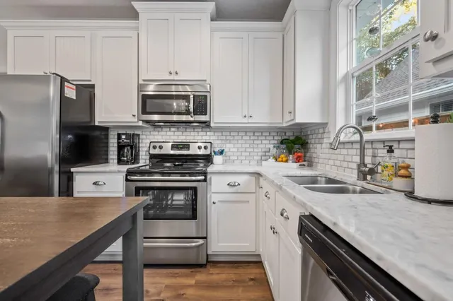 a kitchen with a sink stove and refrigerator