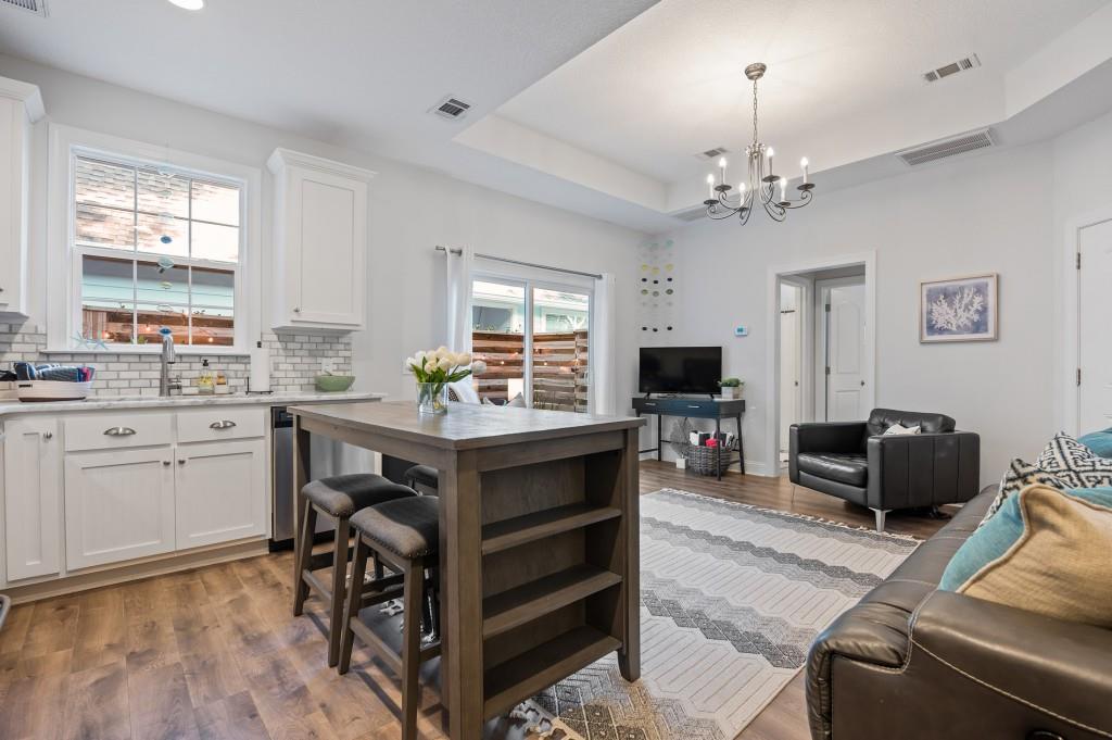 423 Palmetto Street St. Simons, GA 31522 - Photo 10 of 38 a living room with furniture flat screen tv and window