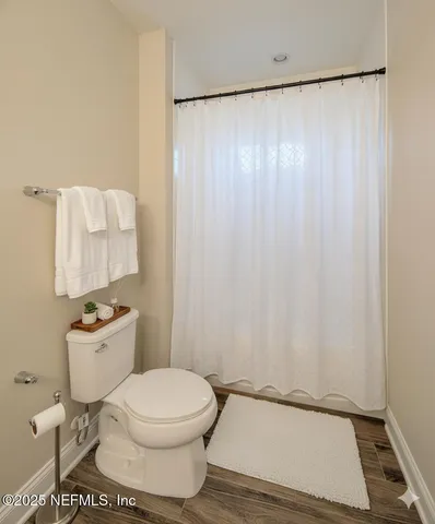 a large kitchen with stainless steel appliances a large counter top a sink a refrigerator and a window