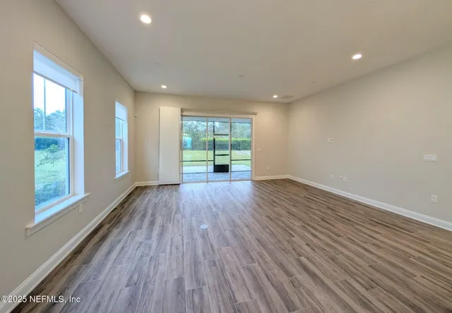 a dining room with furniture a chandelier and window