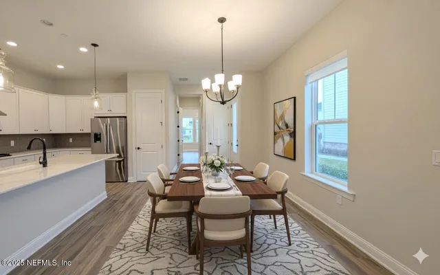 a view of a kitchen with a sink and wooden floor