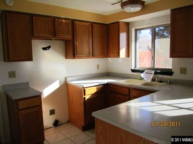 164 Roughing It Road Dayton, NV 89403 - Photo 2 of 11 a kitchen with stainless steel appliances granite countertop a sink a stove and a refrigerator