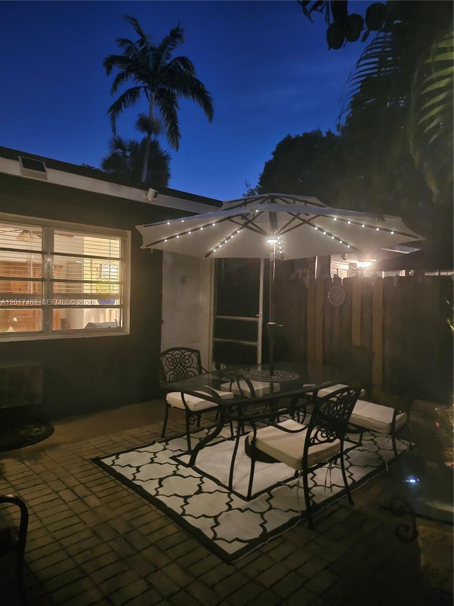 325 Fernwood Road, Unit 10 Key Biscayne, FL 33149 - Photo 3 of 12 a backyard of a house with table and chairs