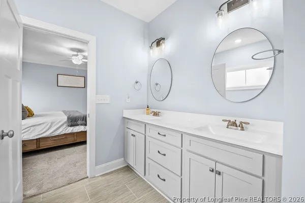 a en suite bathroom with double vanity sinks and a mirror