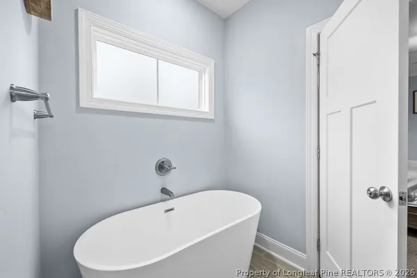 a white bath tub sitting next to a white sink