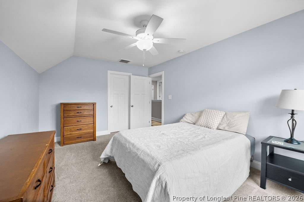 405 Turriff Way Cameron, NC 28326 - Photo 23 of 43 a bedroom with a bed and a chandelier