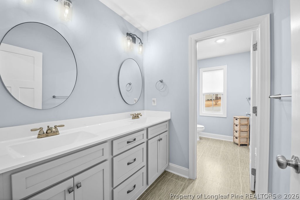 405 Turriff Way Cameron, NC 28326 - Photo 24 of 43 a bathroom with a double vanity sink and a mirror
