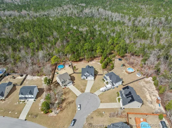 an aerial view of a house with backyard