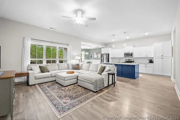 a living room with furniture and kitchen view