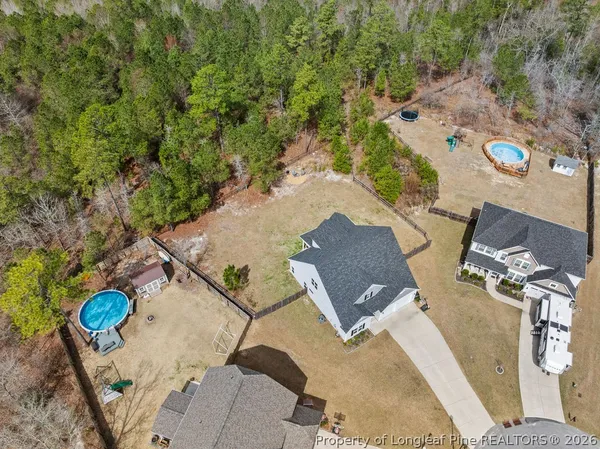 an aerial view of a house with a yard and trees