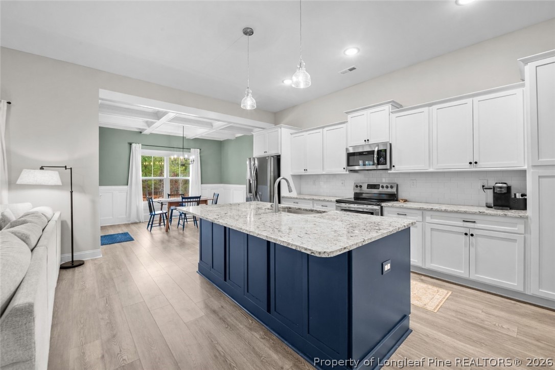 405 Turriff Way Cameron, NC 28326 - Photo 5 of 43 a kitchen with a sink stove and cabinets