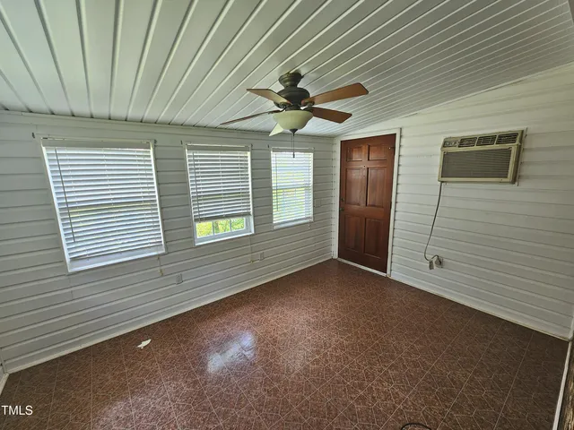 a view of a livingroom with wooden floor and a fireplace