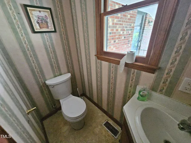 a white toilet sitting next to a bathroom sink